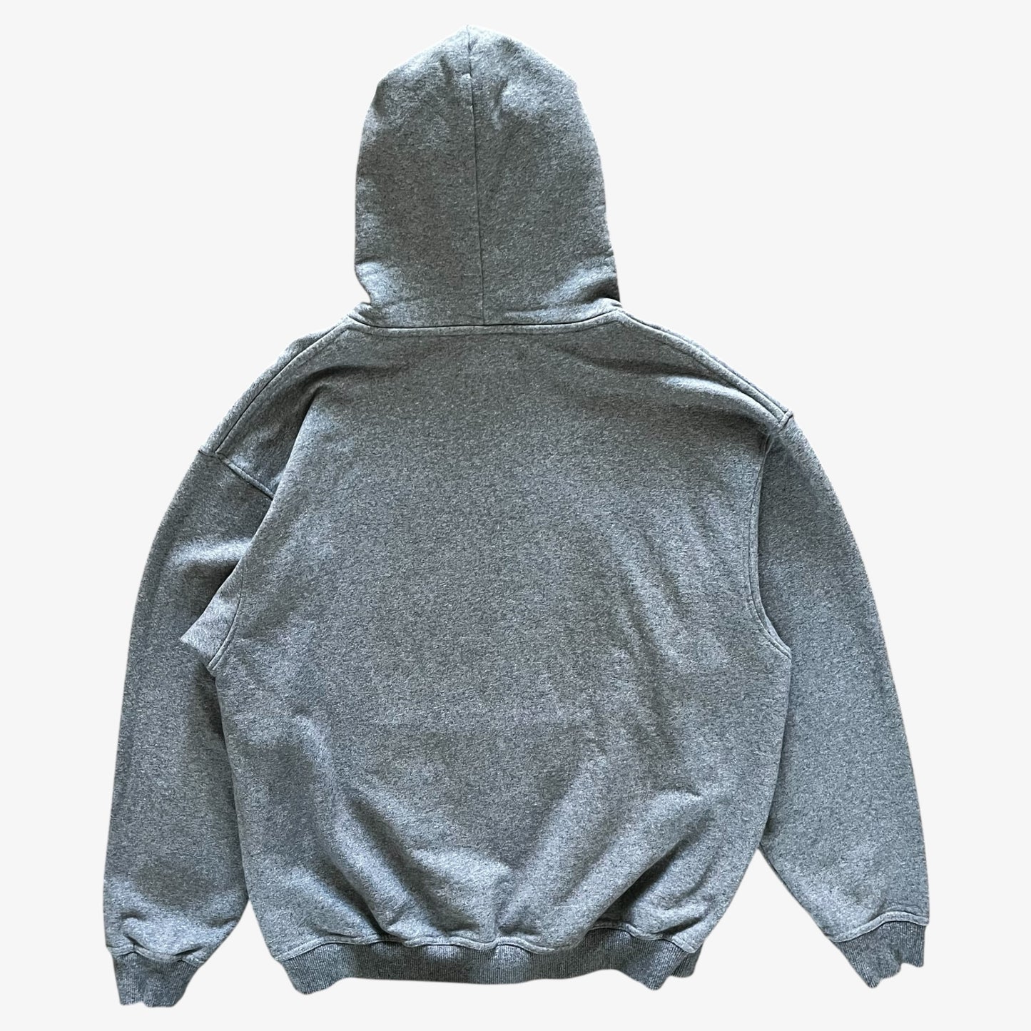 A heather grey pullover hoodie shown from the back, laid flat against a light grey background.