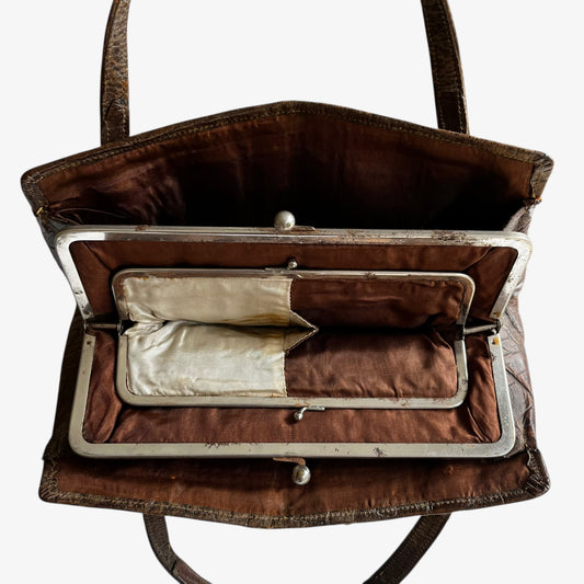 Close up of internal purses inside of a vintage 1950s crocodile embossed dark brown leather shoulder bag.