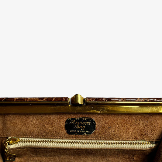 Close up of made in England Riviera label inside of a vintage 1950s Riviera crocodile embossed brown leather shoulder bag.