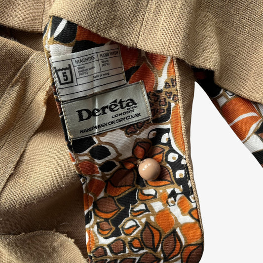 Close-up of a 1970s brown women's jacket with a patterned inner lining in orange, black, and white, featuring a visible Derêta London brand label.