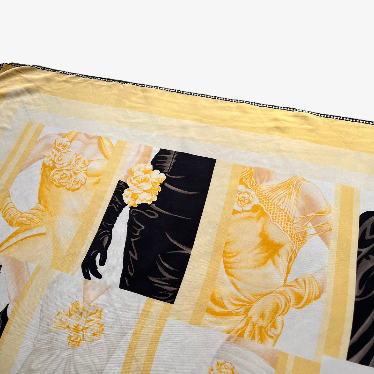Close up of art deco wedding dress print on women's vintage 80s Christian Dior yellow silk scarf with a black and white houndstooth trim.