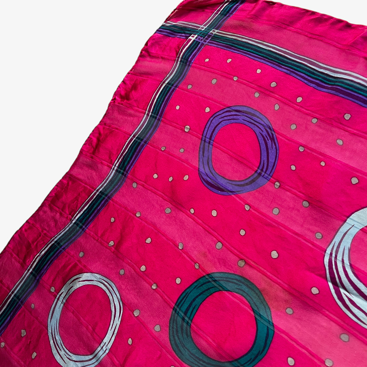 Striped design on women's vintage 80s Givenchy pink silk scarf with a colourful polka dot pattern.