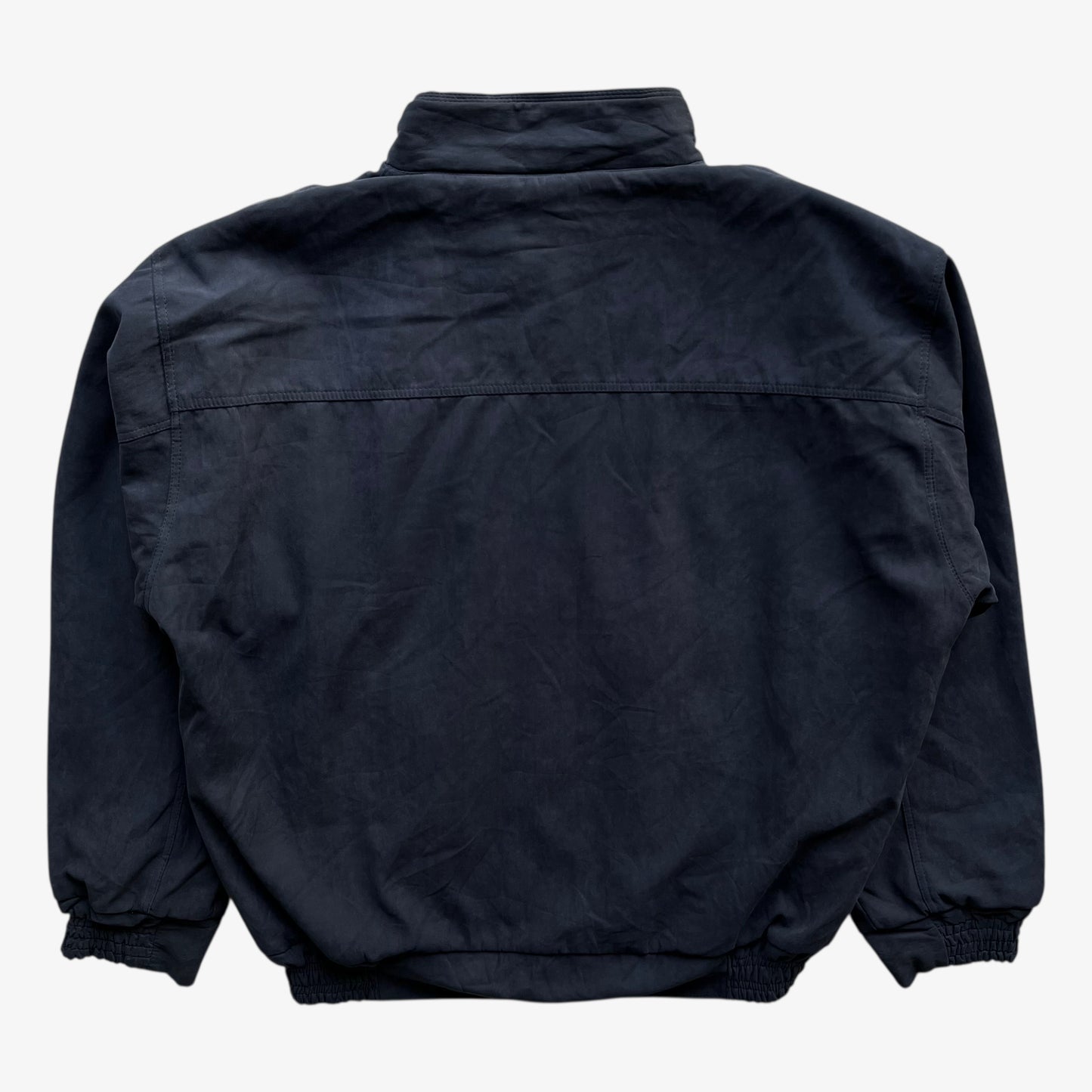 Back of men's vintage 80s Guess USA navy driving jacket.