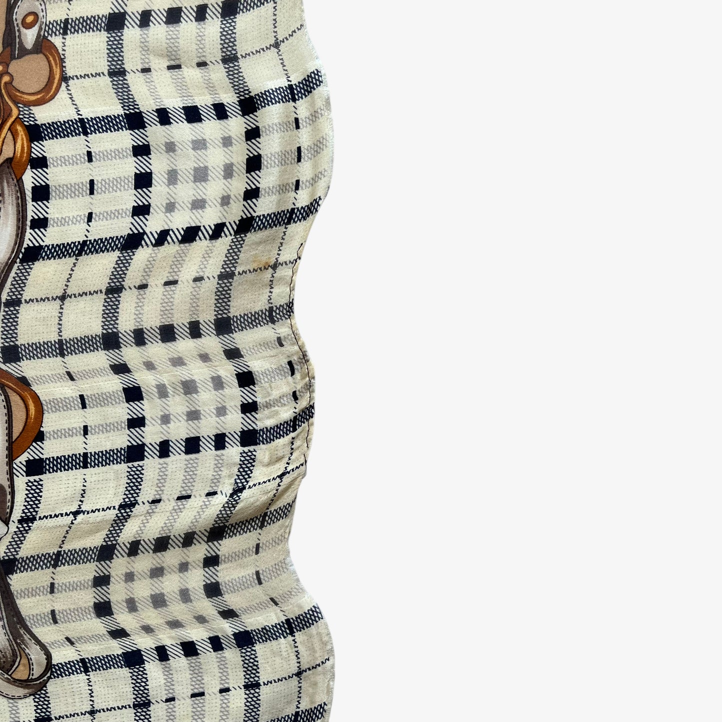 Patina on women's vintage 80s Paolo Gucci equestrian buckle and tartan print brown silk scarf.