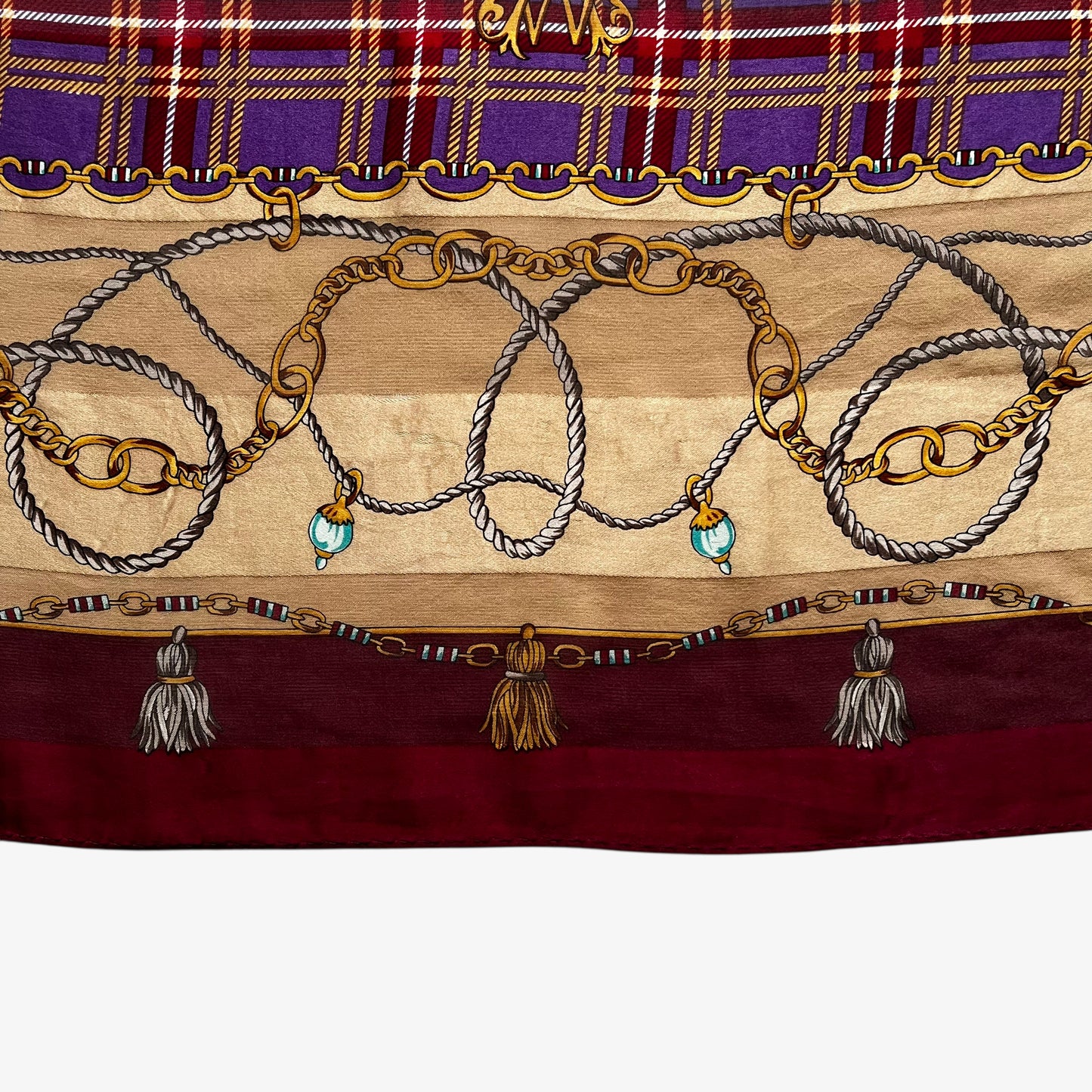 General wear on a women's vintage 80s Paolo Gucci red silk scarf features a gold medallion chain and purple tartan print.