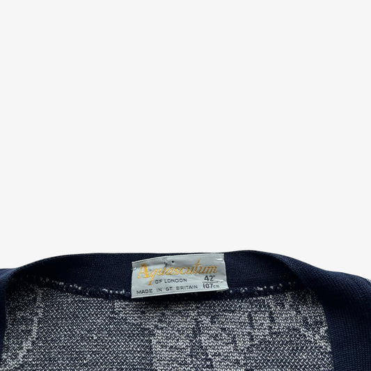 Close up of a vintage Aquascutum label on a white background.