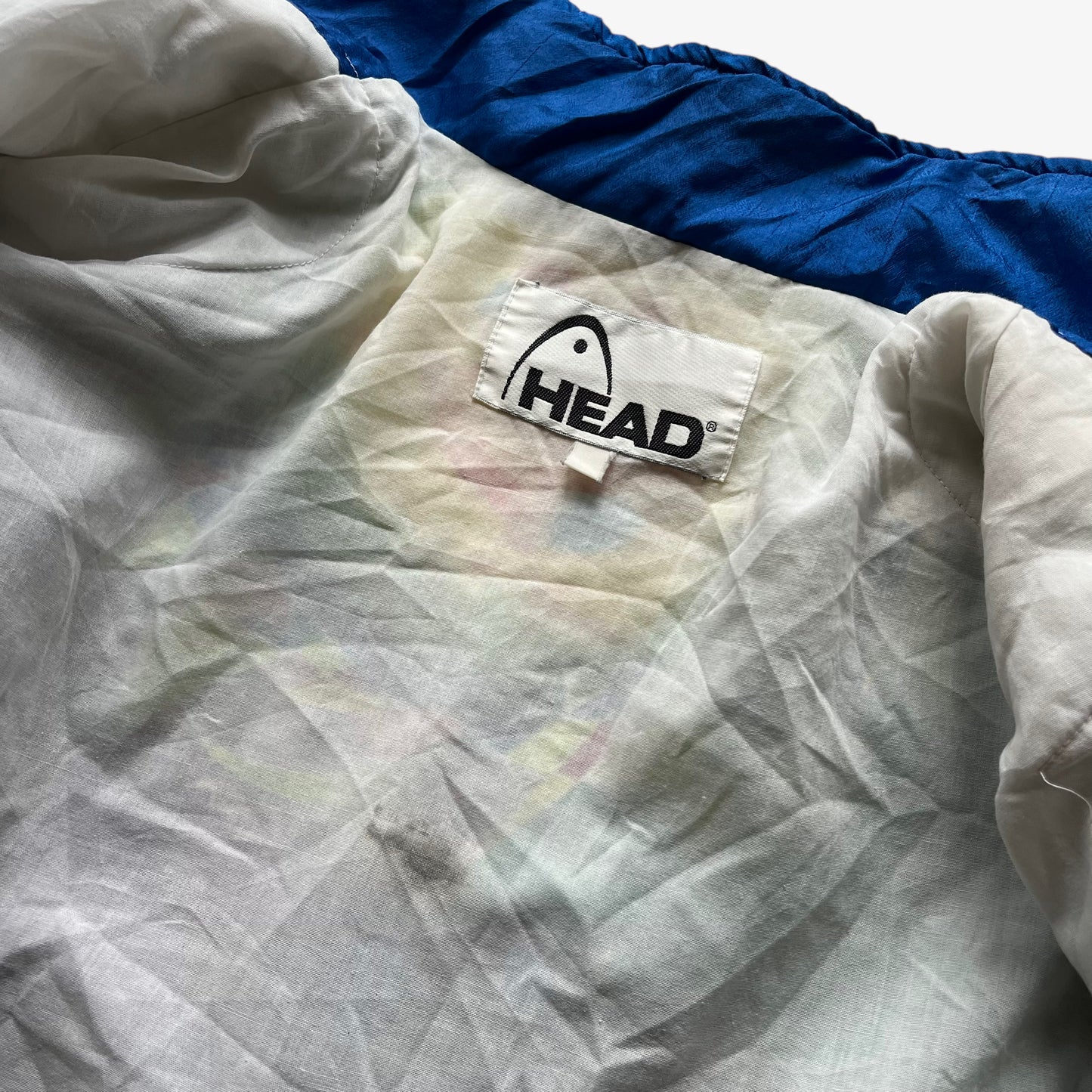 Patina of vintage 80s women's Head abstract face print colourful track jacket with shoulder pads.