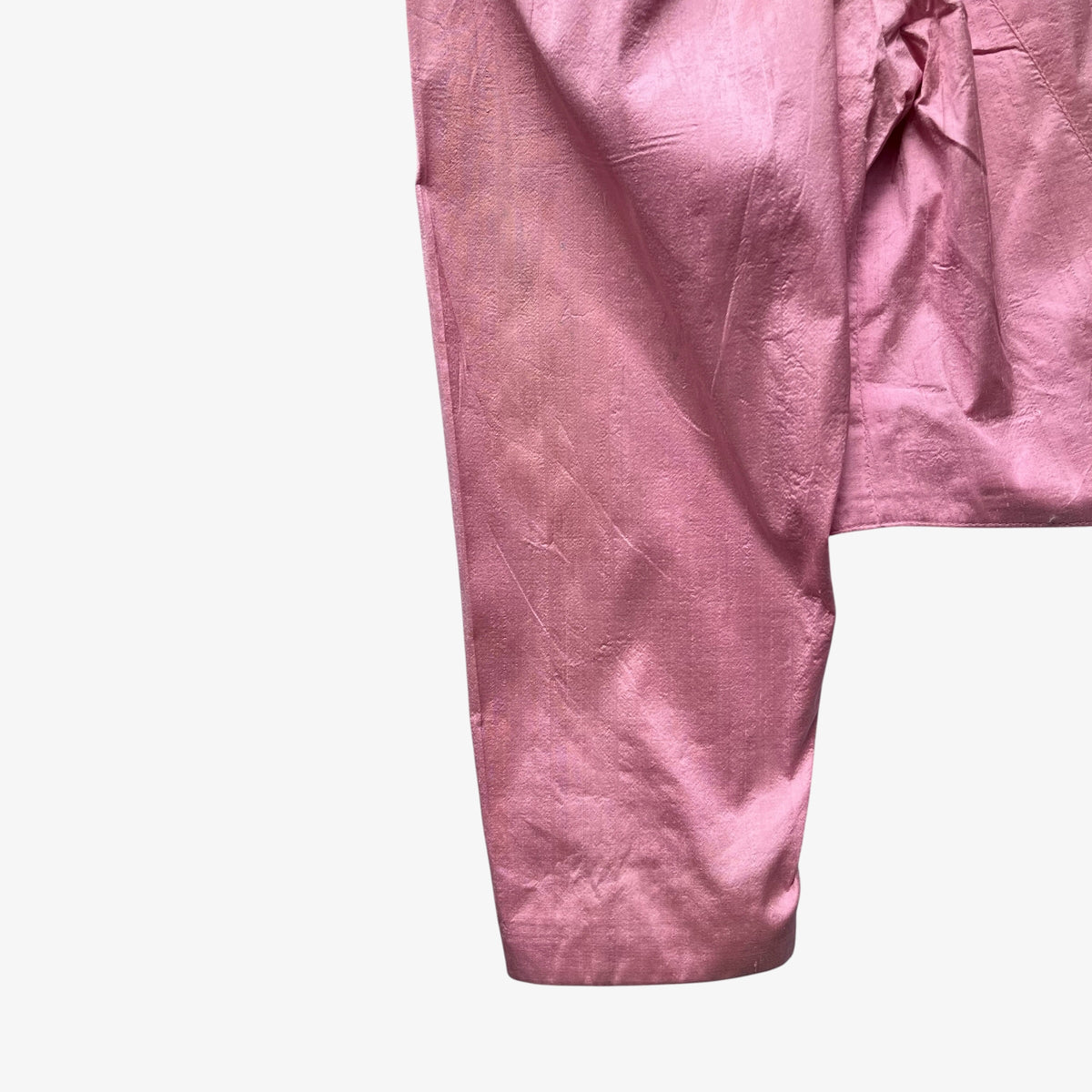 A close-up of the sleeve of a pink trachten jacket.