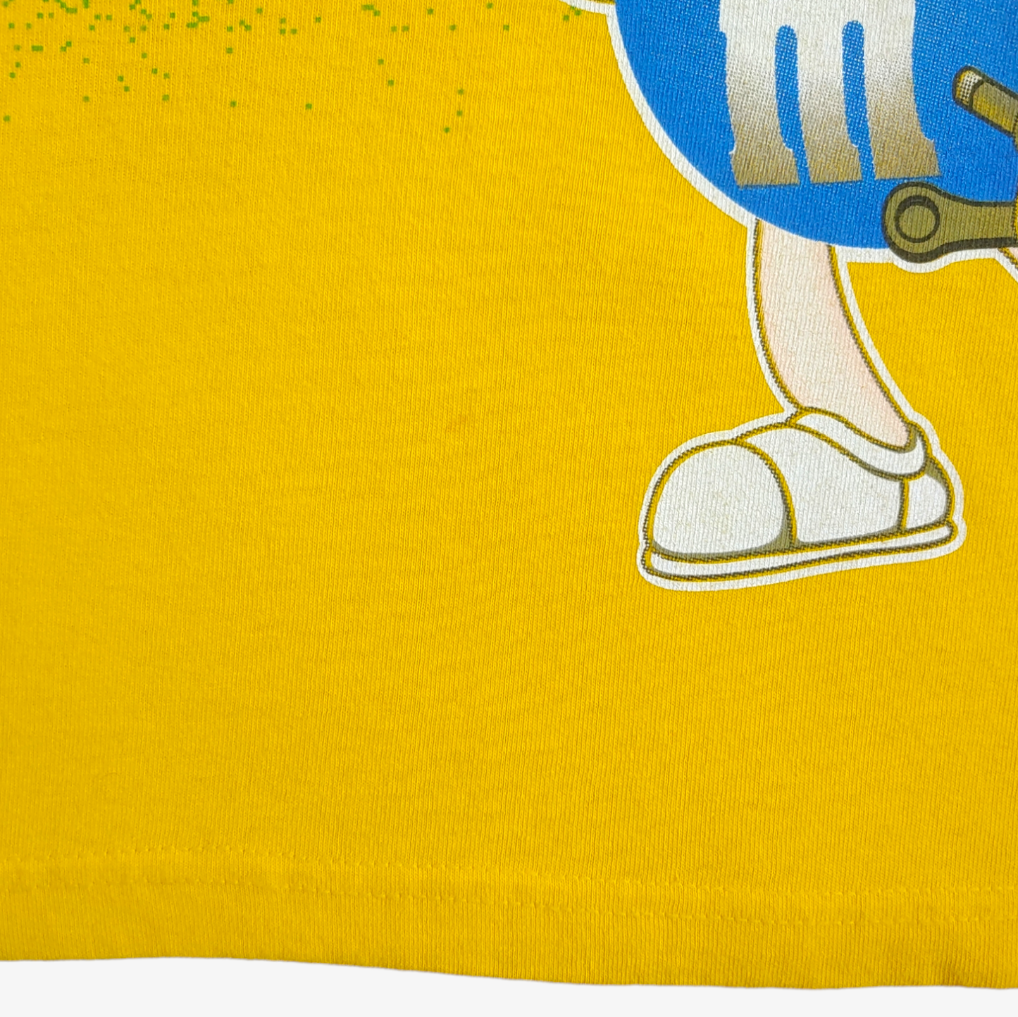 Hem of vintage 90s Ernie Irvan M&M NASCAR racing team yellow t-shirt.