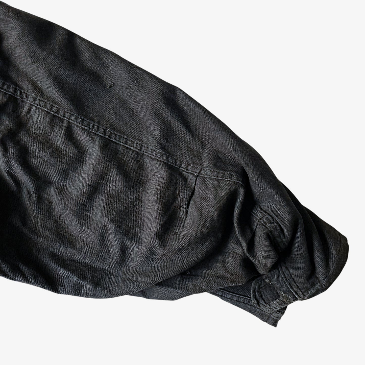 Sleeve of vintage 90s men's Alpha Industries brown M65 cold weather field jacket.