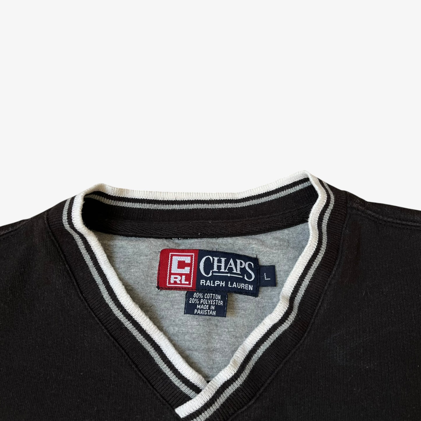 Vintage 90s Ralph Lauren Chaps label stitched inside of a men's black sweatshirt.