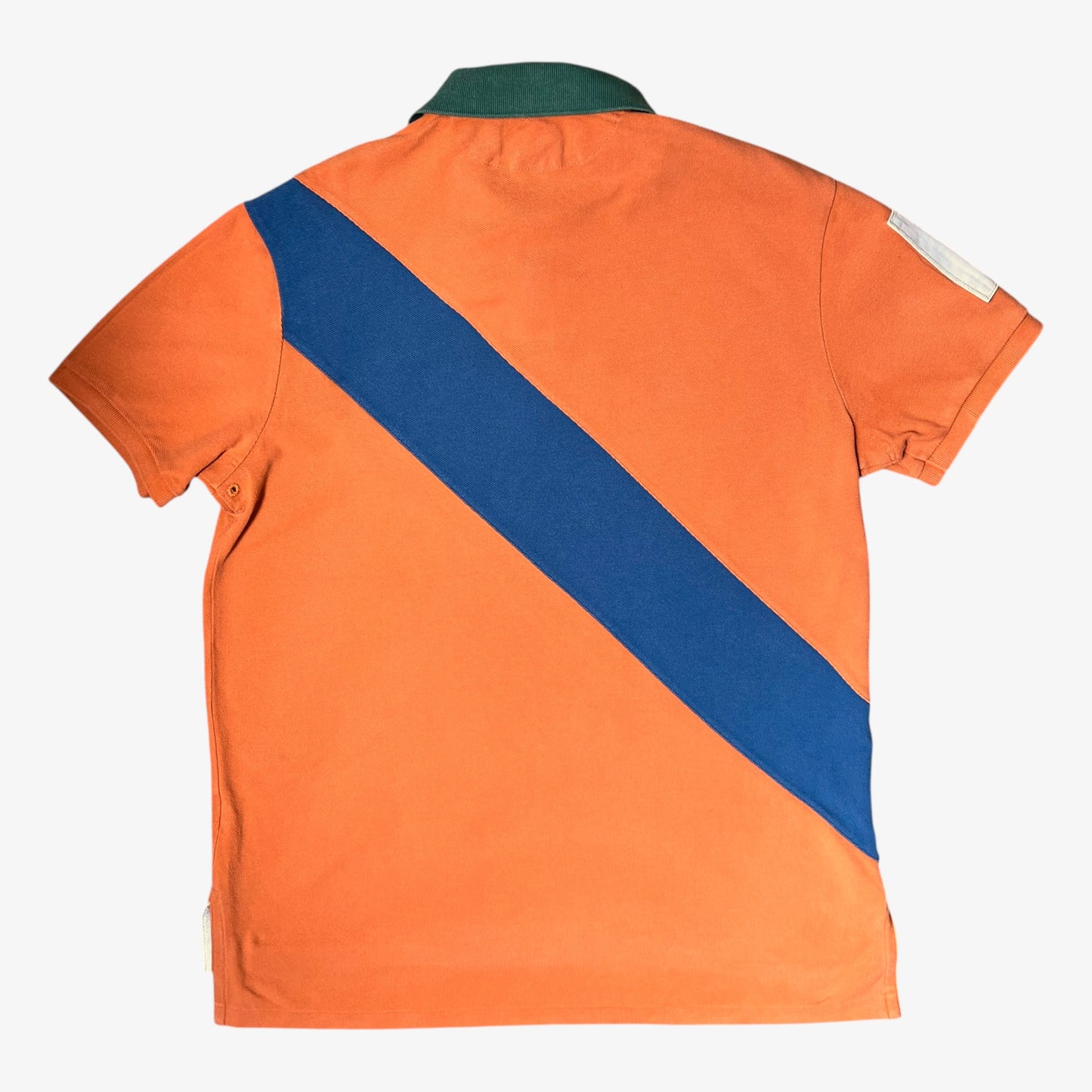 Back of vintage Ralph Lauren orange rugby shirt with blue diagonal stripe and logo on a white background.