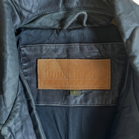 Suede label inside a vintage 90s men's Timberland black leather jacket.