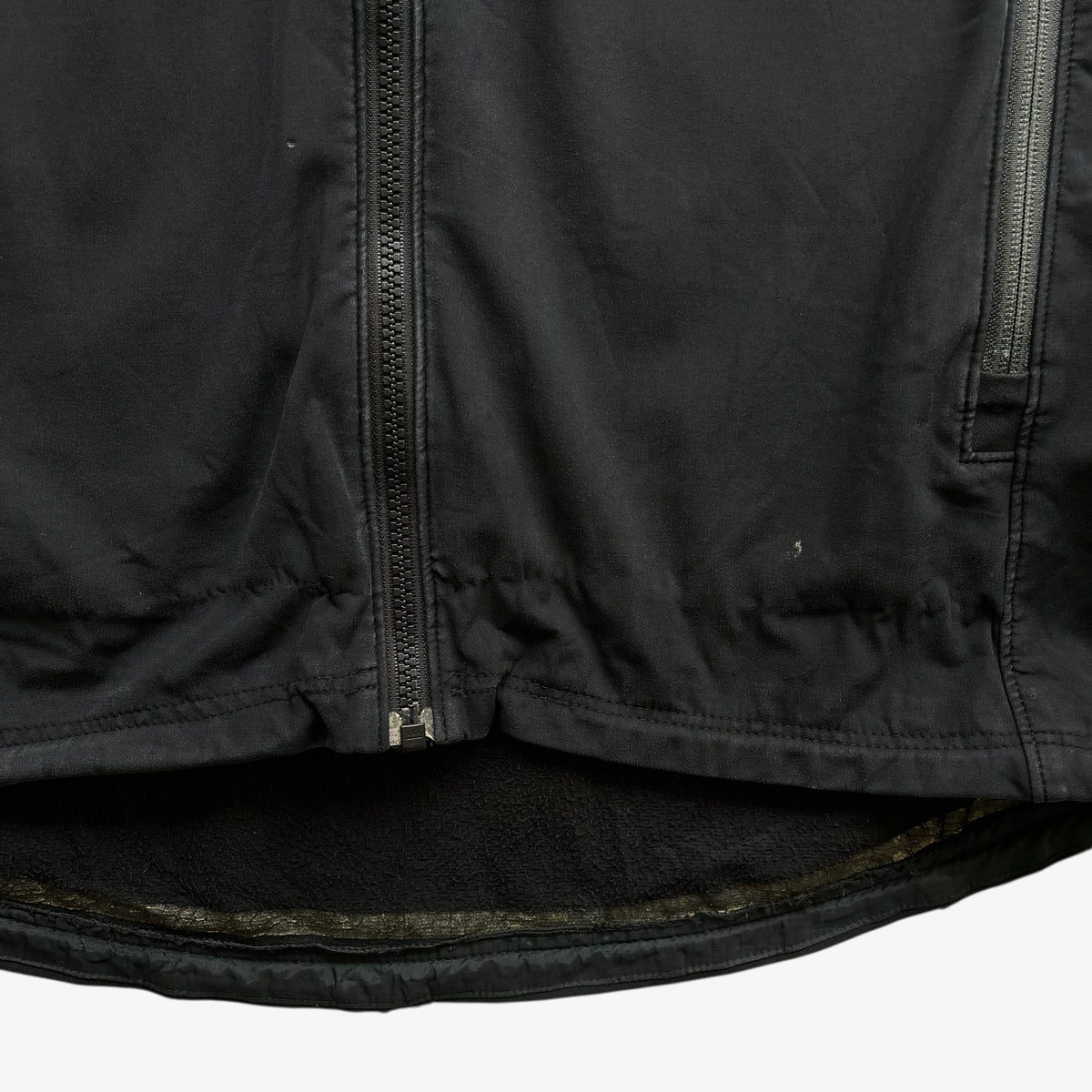 Patina on men's vintage Y2K Arcteryx Polartec black hooded utility jacket.