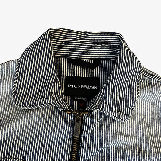 Emporio Armani label stitched inside of men's faded blue and white striped workwear jacket.