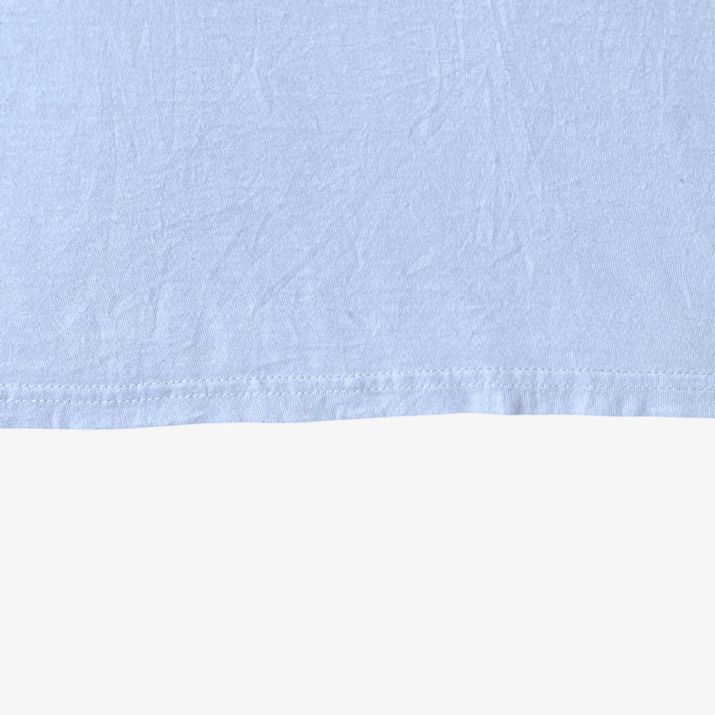 Hem wear on vintage Y2K men's The Hundreds Gigi woman print white t-shirt.