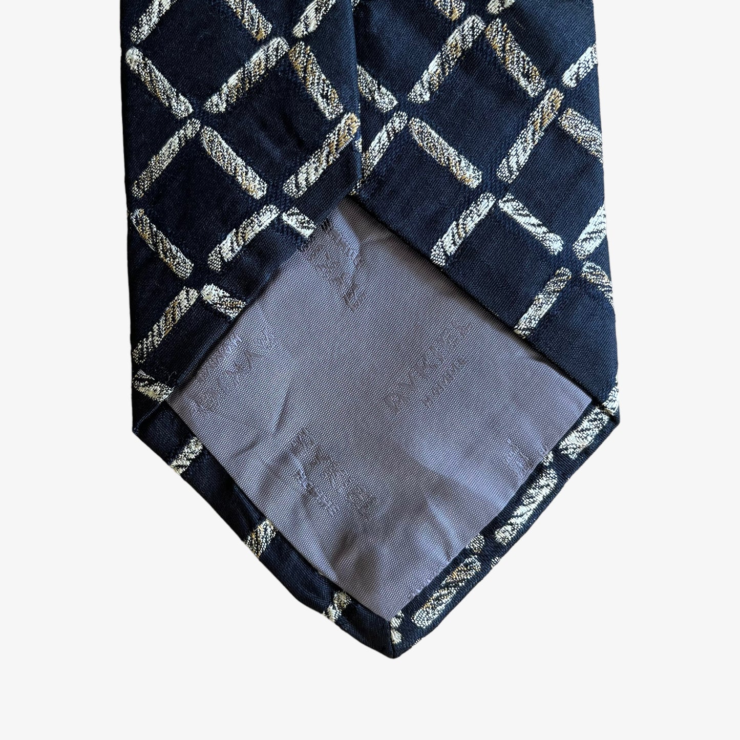Close up of logo on vintage Y2K Sonia Rykiel homme abstract print silk tie.