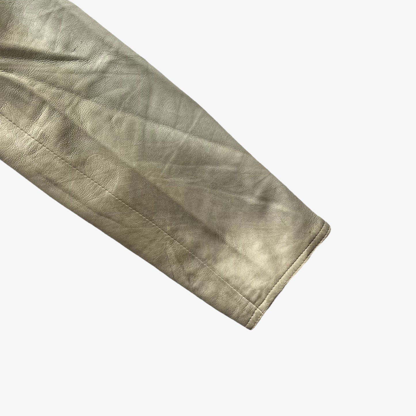 Cuff of women's vintage Y2K Armani Jeans cream leather blazer.