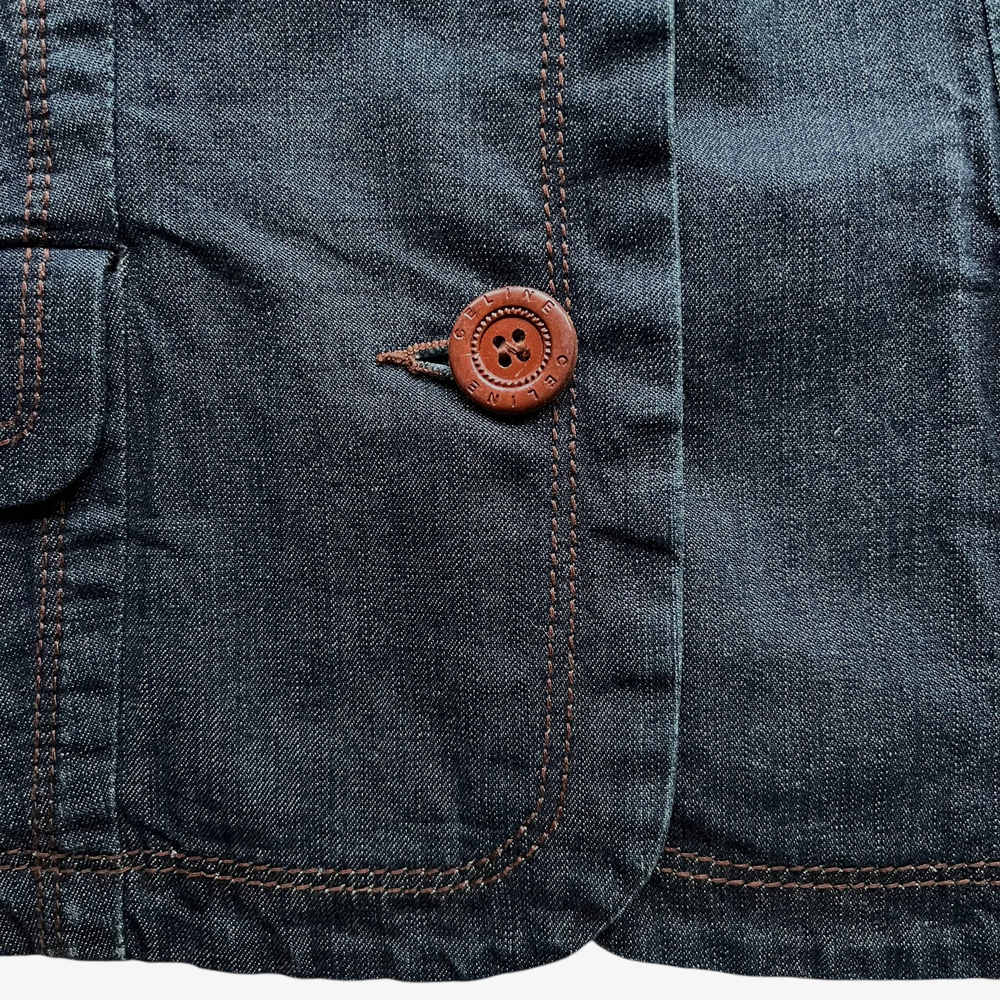 Engraved Celine buttons on a vintage Y2K women's blue denim jacket.