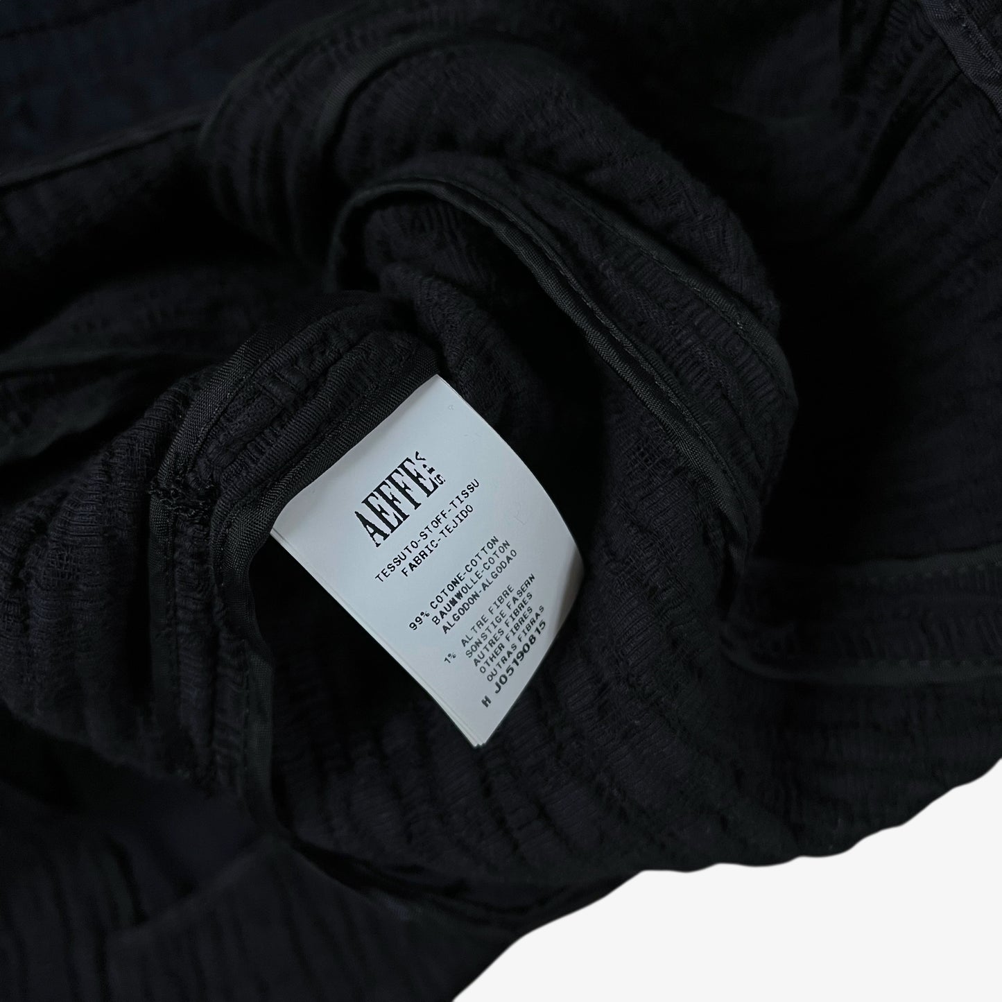 Inside label of vintage Y2K Moschino women’s black ribbed blazer.