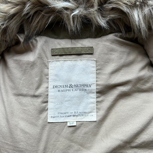 Close-up of the interior neck label of a Ralph Lauren Denim & Supply down puffer gilet, showing the brand name on a beige fabric label beneath a detachable faux fur-trimmed collar.