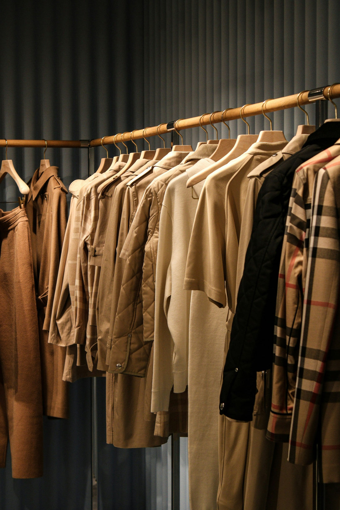 Rail filled with vintage and designer clothing, including a retro 90s Burberry nova check shirt.