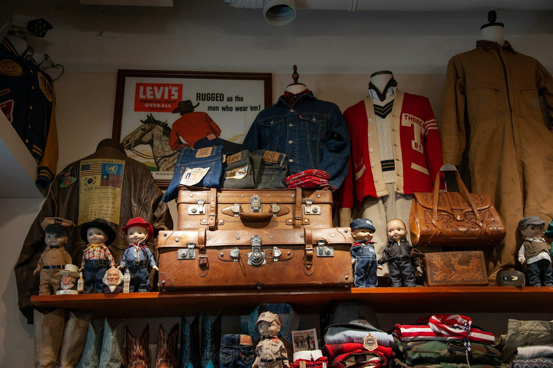 Collection of vintage clothing and accessories hung up in a retro store.