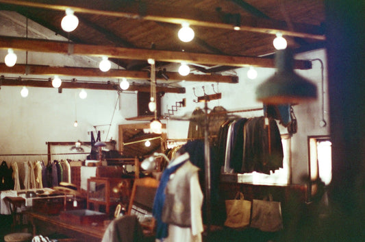 Inside of a vintage clothing store, filled with men's retro t-shirts and jackets.
