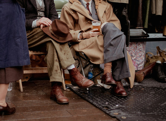 Two male models wearing a vintage 80s oversized suit with a 90s wool coat.