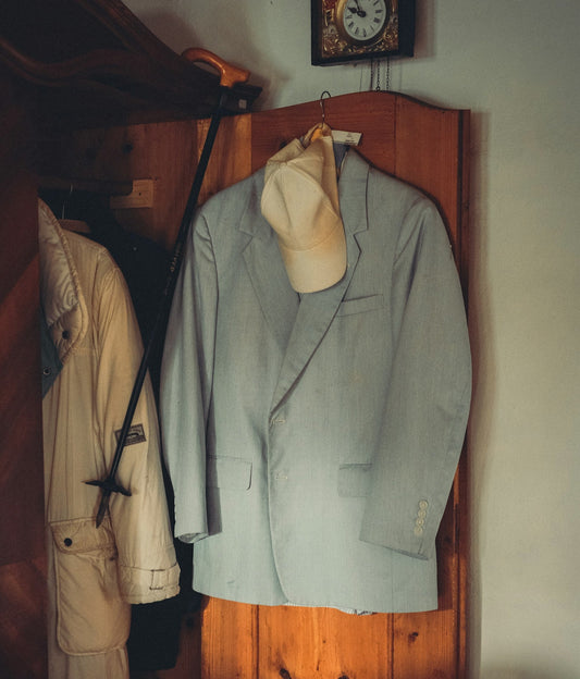 Close up of a men's vintage blazer and a retro cap.
