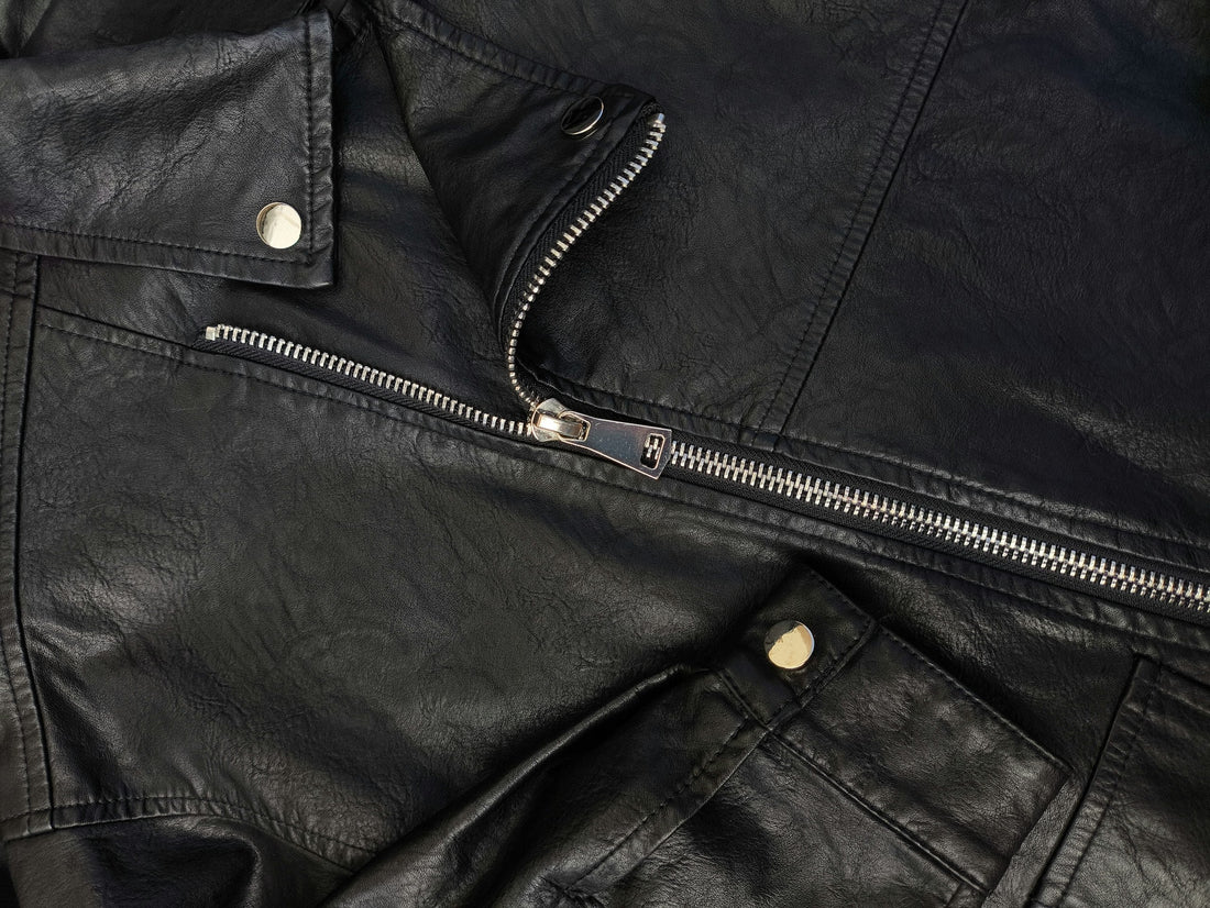 Close up of the patina on a vintage 90s black leather biker jacket.