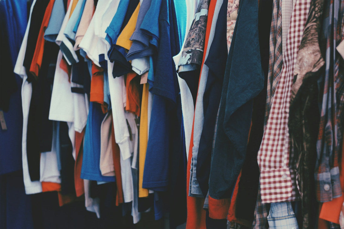 Rail of colourful vintage 90s t-shirts and shirts.