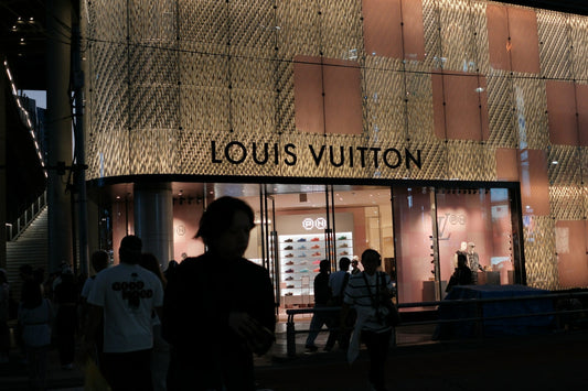 Louis Vuitton store front with people flocking towards it.