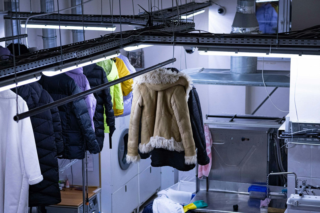 Vintage jackets being washed on a conveyer belt.