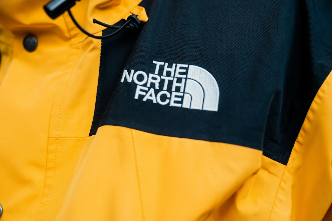 Close up of vintage 90s The North Face yellow utility jacket.