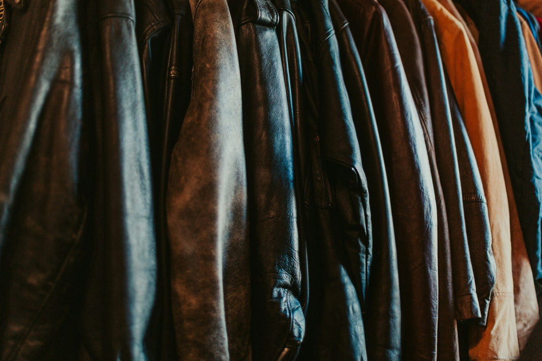 Close up of the patina on a row of men's vintage 80s leather biker jackets.