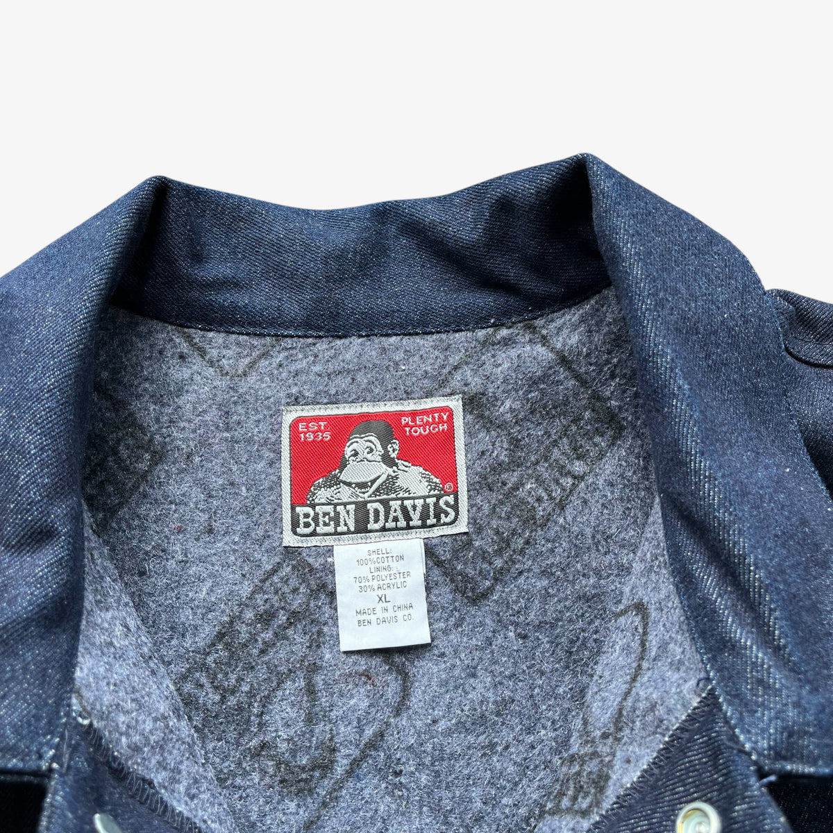 Close-up of the inside collar of a dark blue denim button-up shirt, showing the Ben Davis brand label.