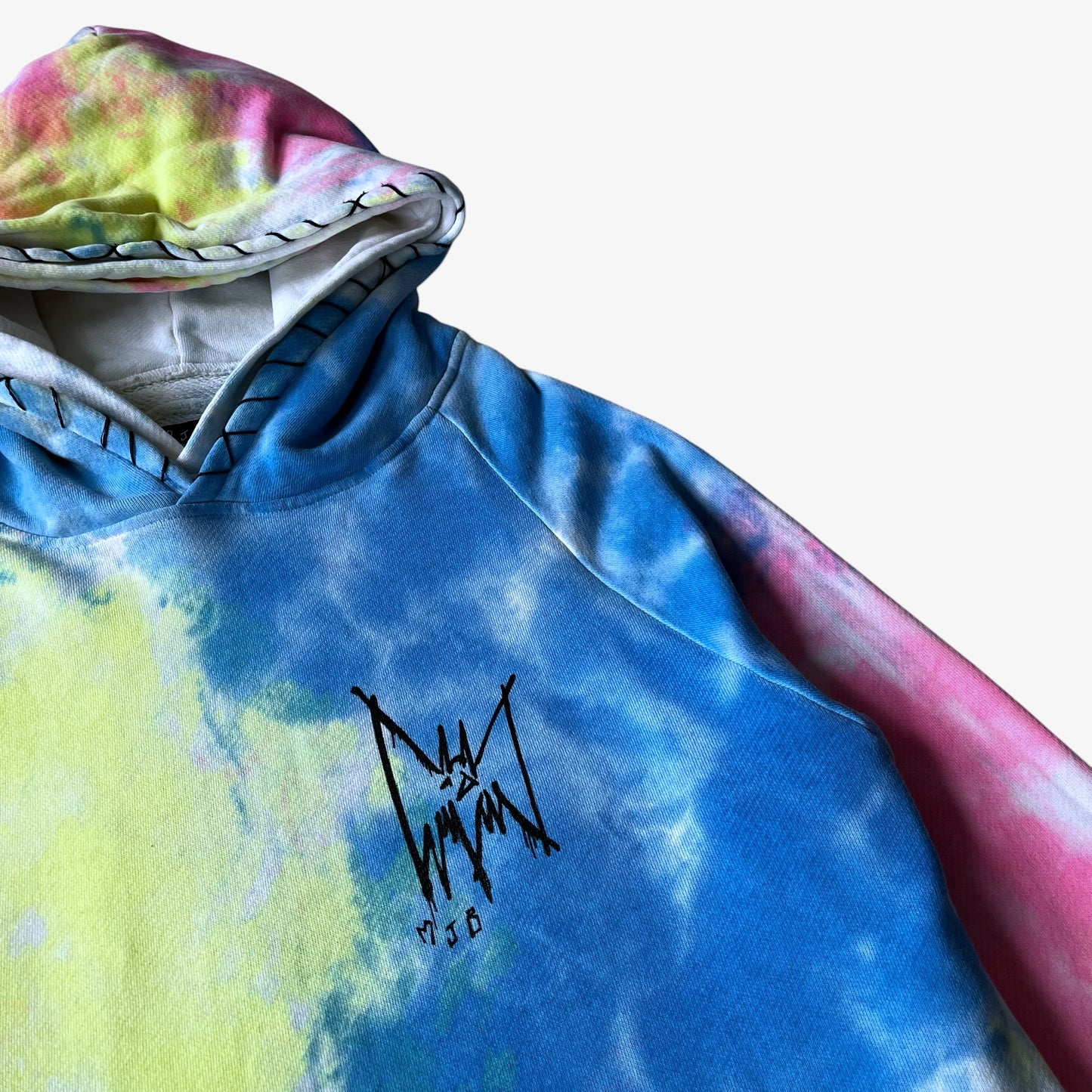 Colourful tie dye hoodie with a logo on a white background.