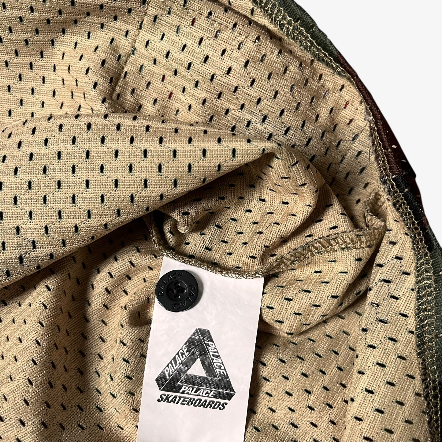 Internal Palace label stitched inside of men's kawaii green camouflage baseball jersey.