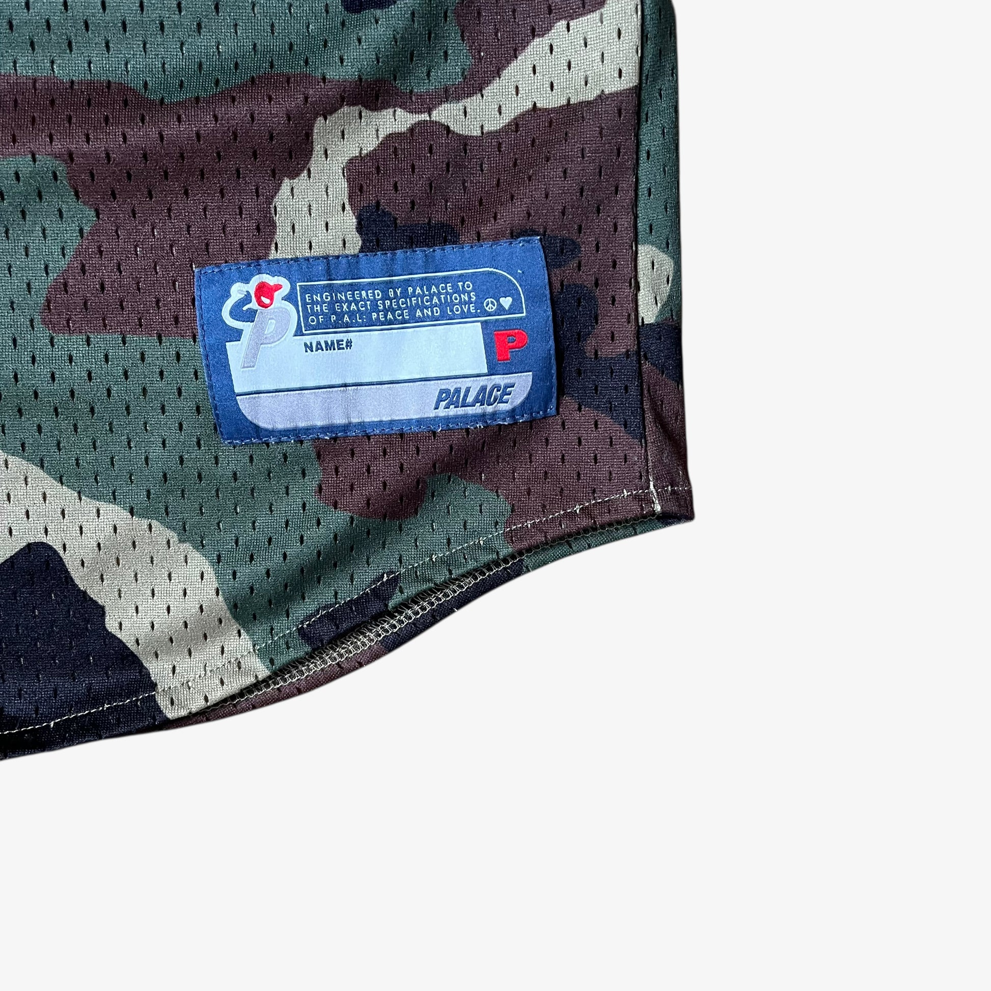 Stitched brand tag on men's Palace kawaii green camouflage baseball jersey.