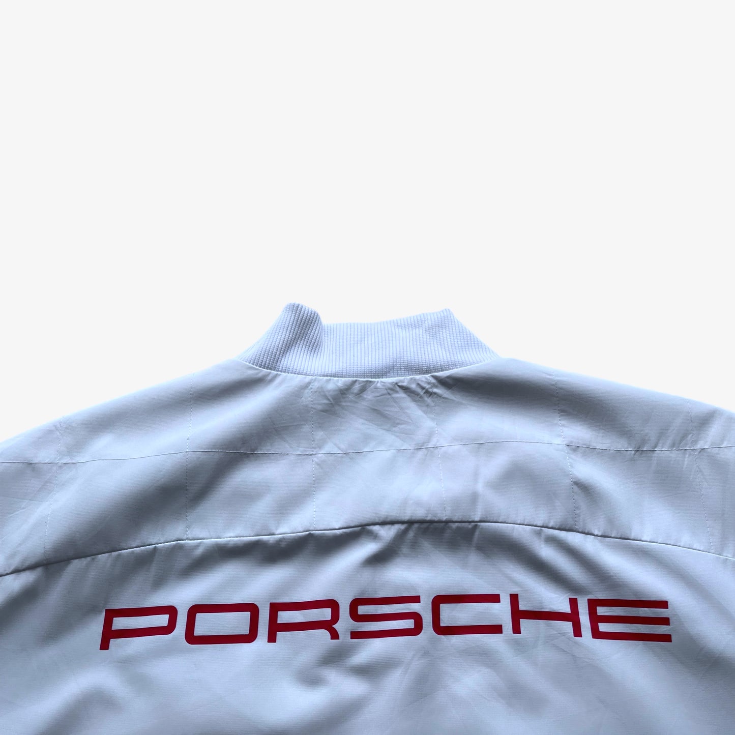 Porsche printed spell out on the back of men's Puma 911 GT3R white driving jacket.