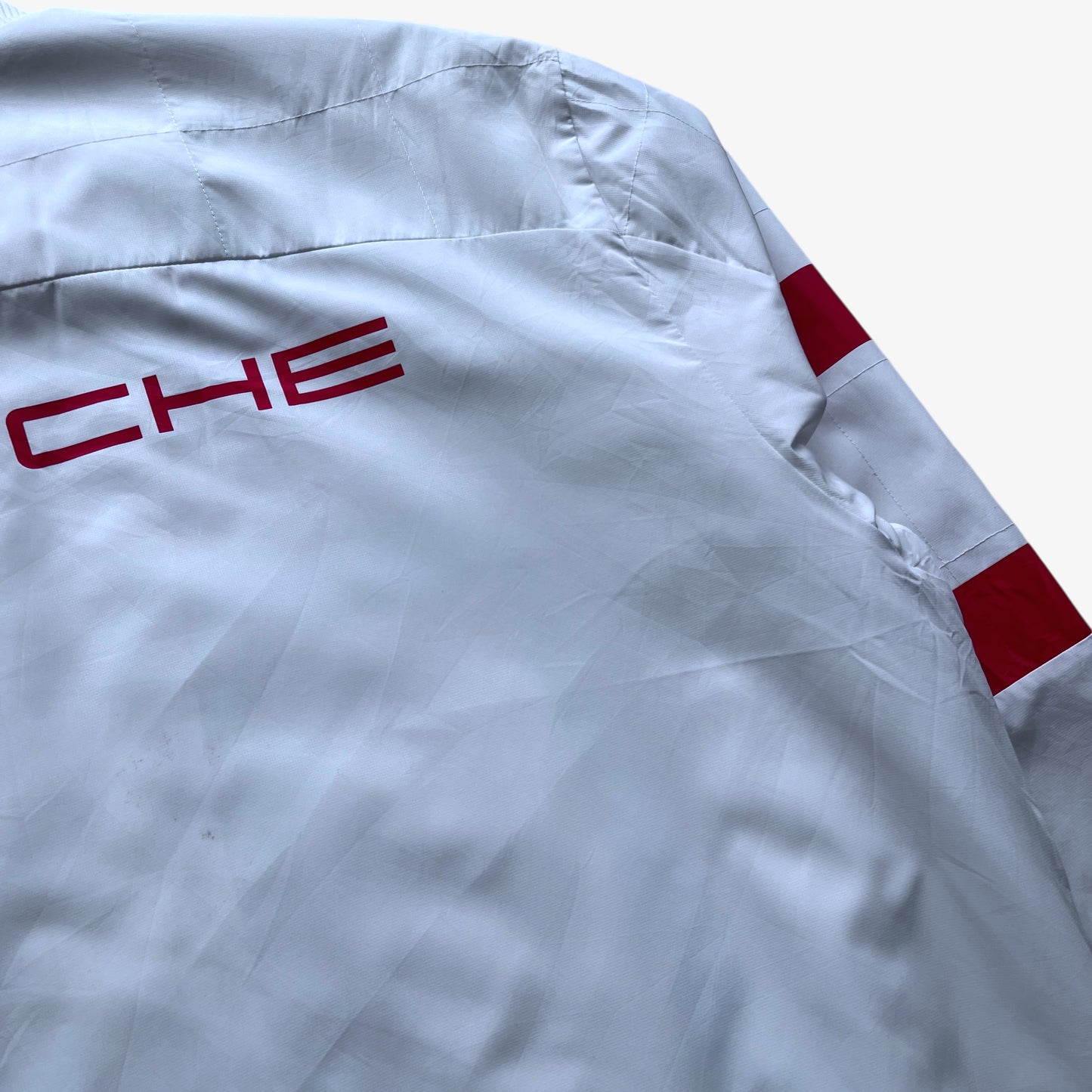 Wear on men's Puma Porsche 911 GT3R spell out print white driving jacket.