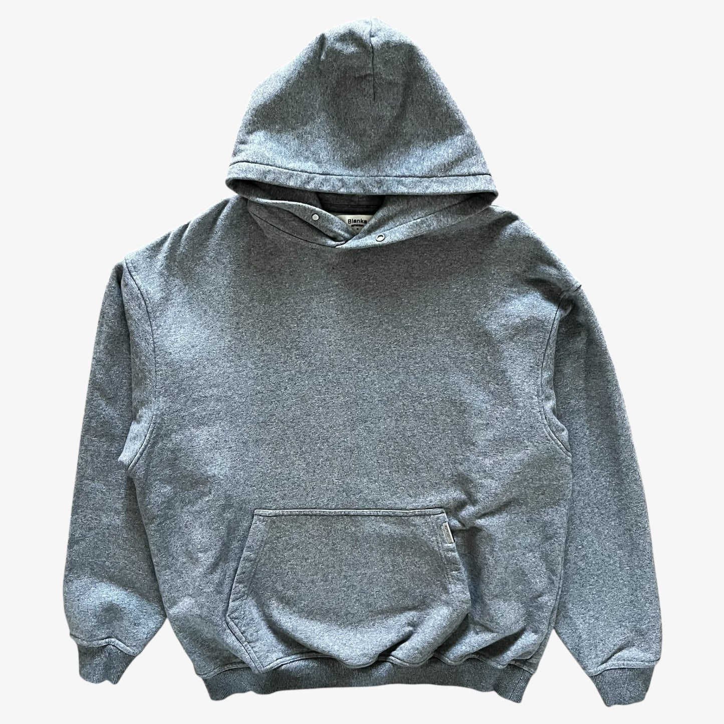 A classic heather grey pullover hoodie with a front kangaroo pocket, laid flat against a light grey background.