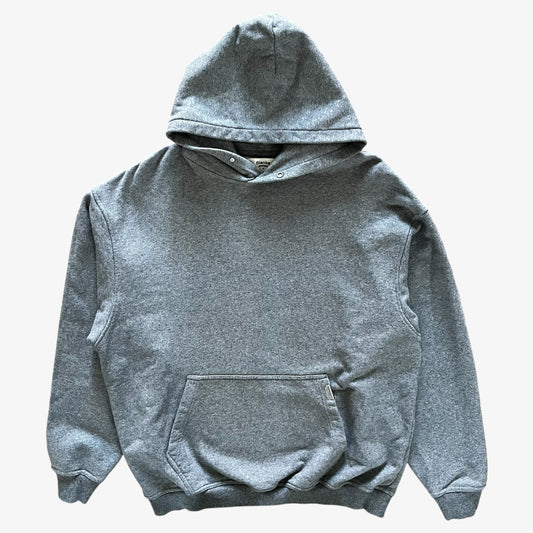 A classic heather grey pullover hoodie with a front kangaroo pocket, laid flat against a light grey background.