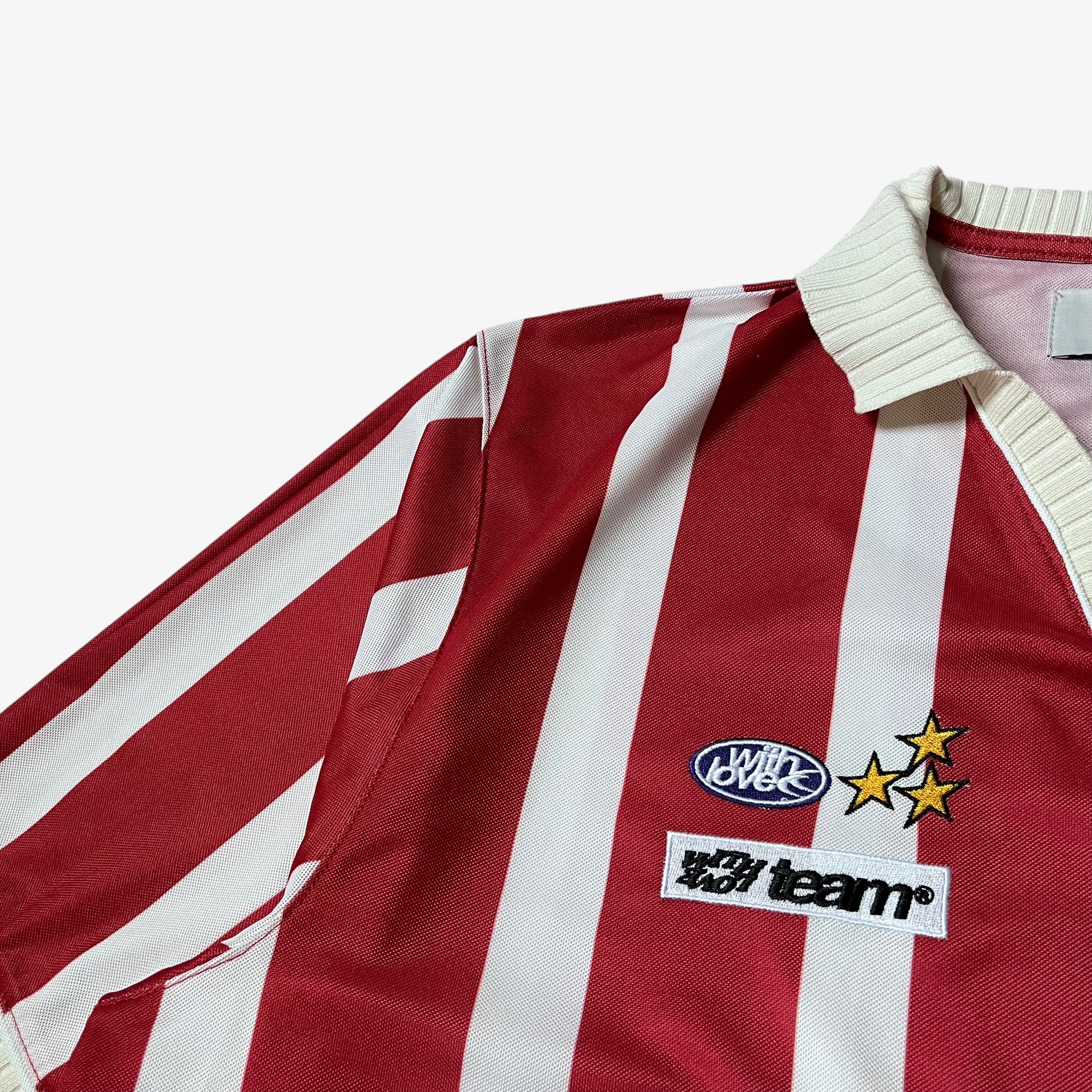 Embroidered logo on the chest of men's Scuffers red and white striped football jersey.
