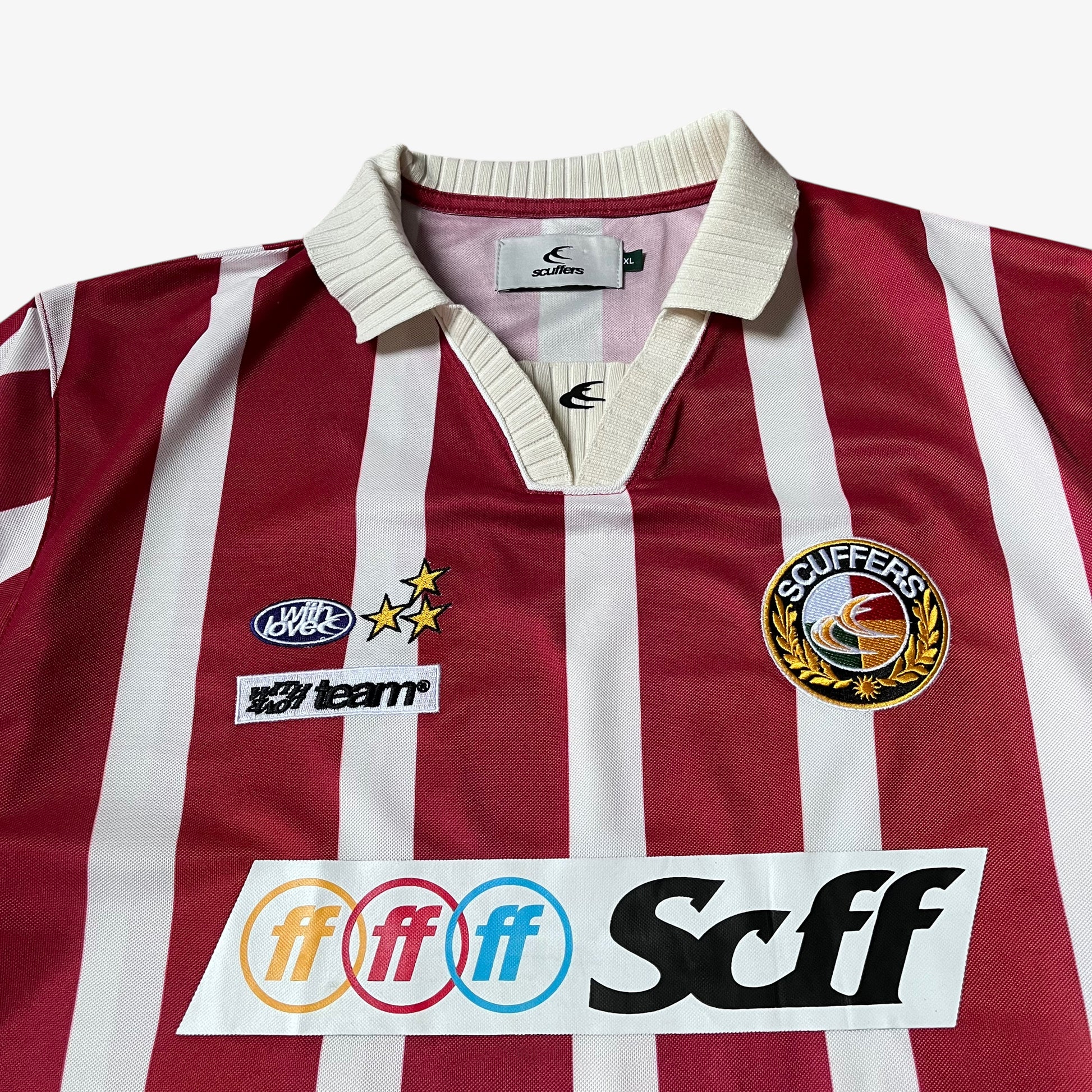 Close up of embroidered and printed spell outs on men's Scuffers red and white striped football jersey.