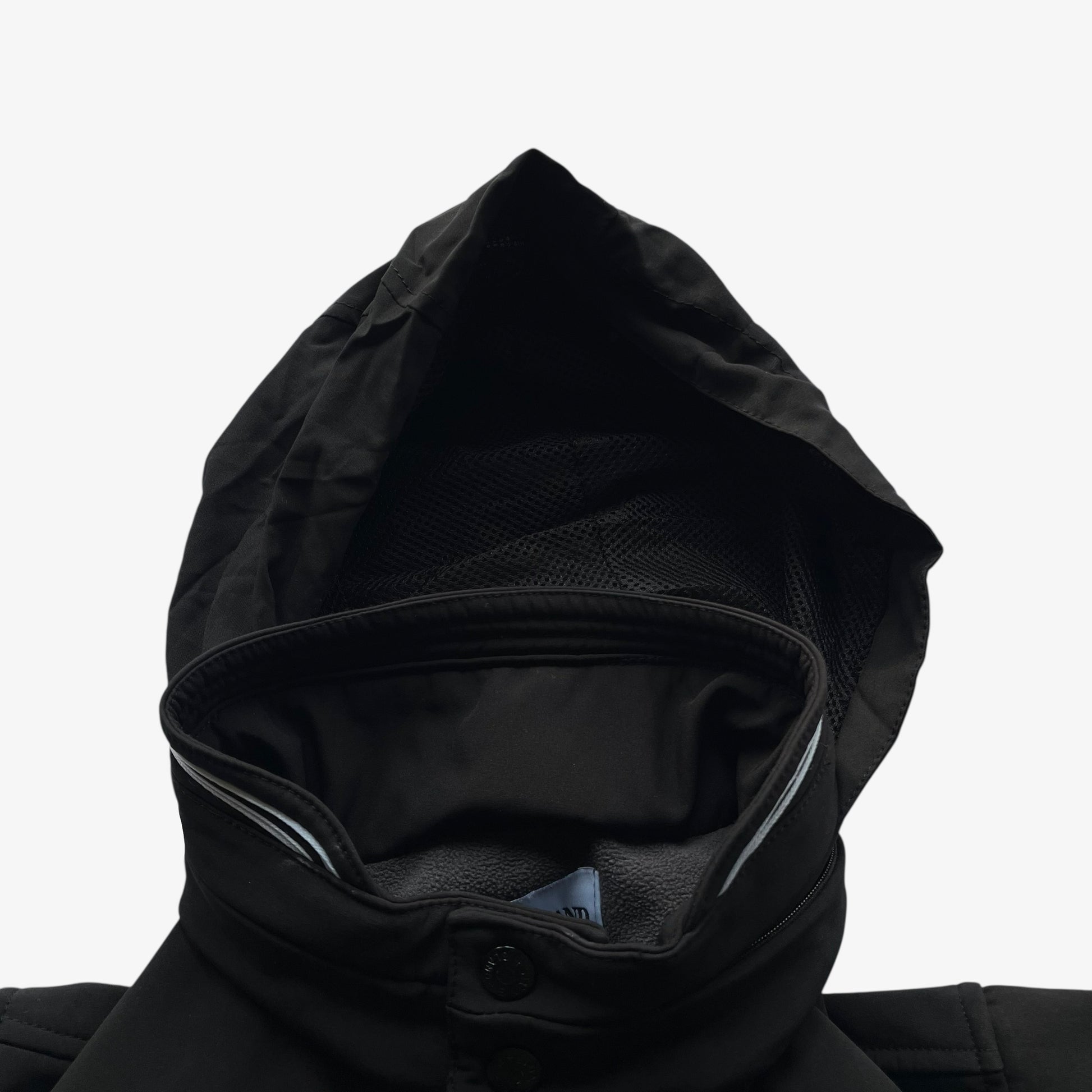 Foldable hood of men's Stone Island Soft Shell R black utility jacket.