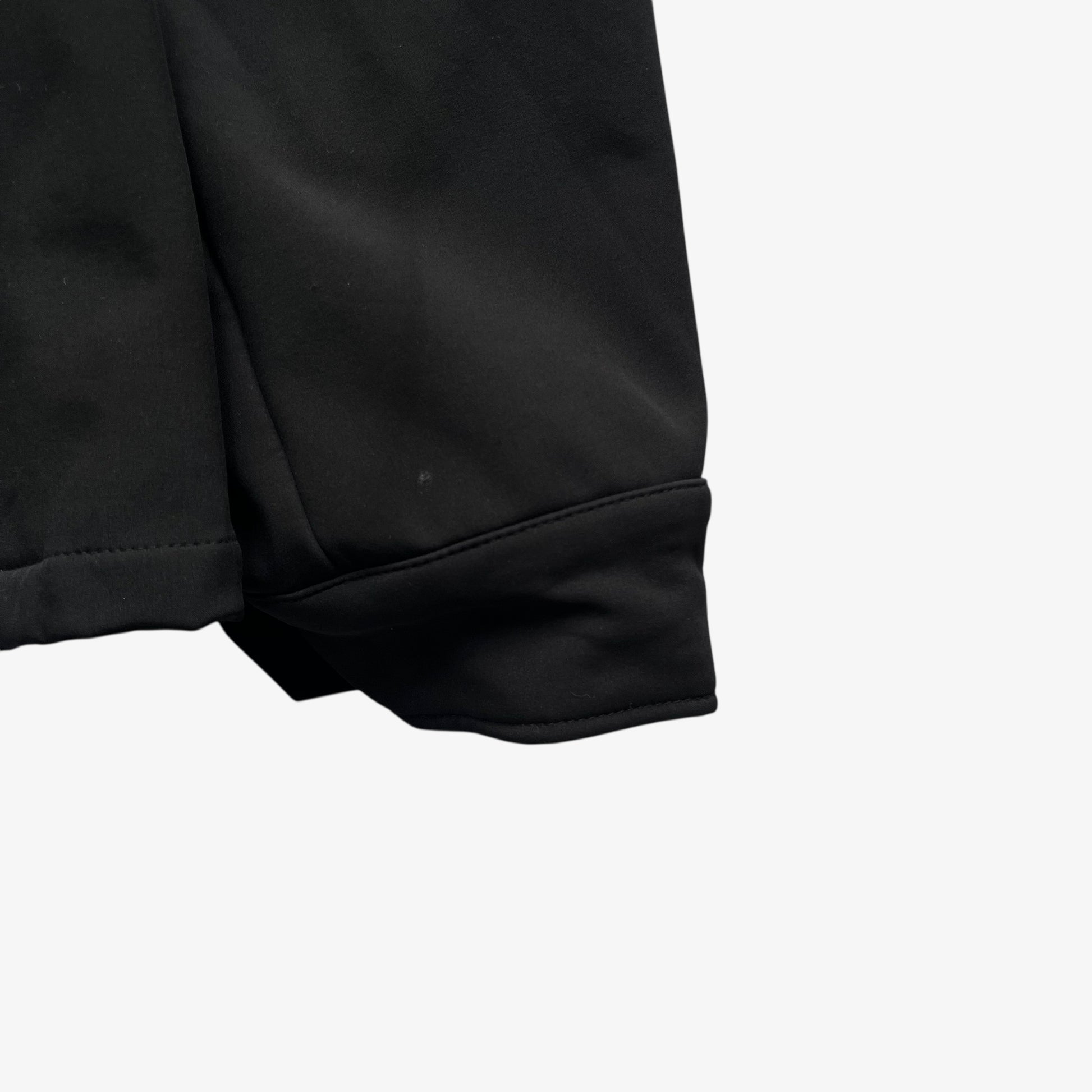 Cuff on men's Stone Island Soft Shell R black utility jacket with foldable hood.