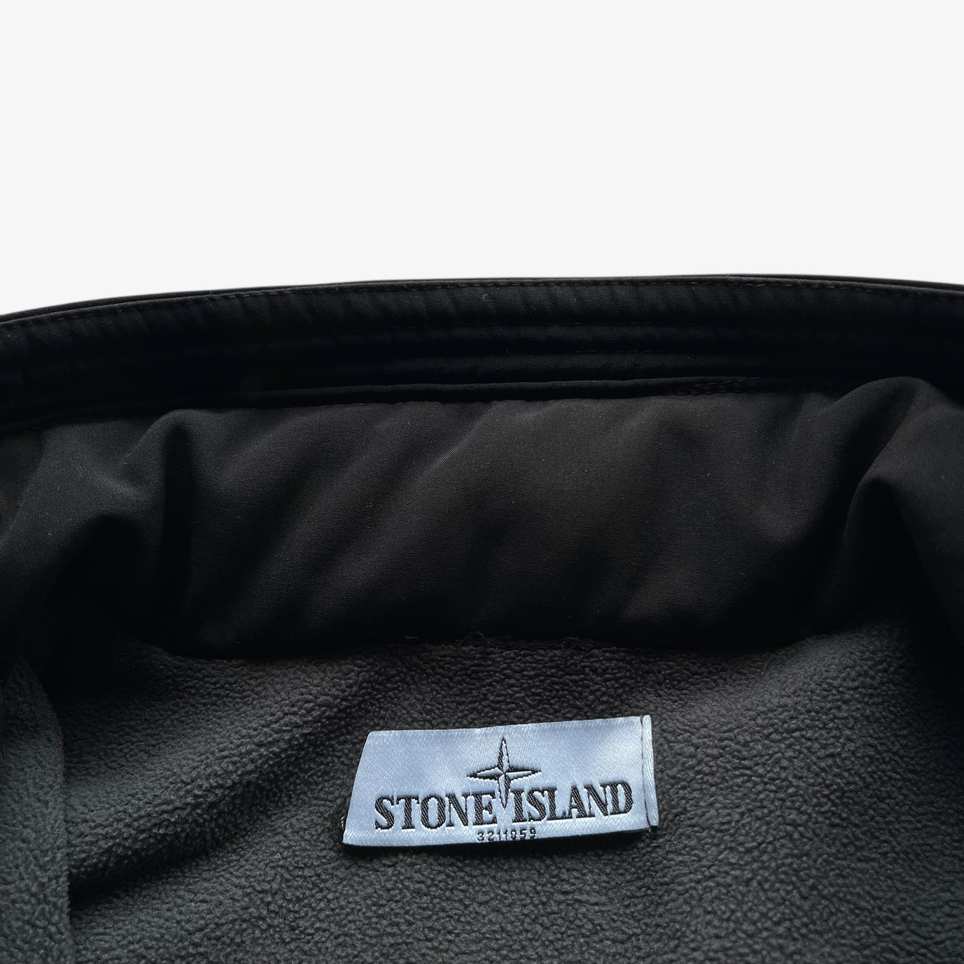 Stone Island stitched inside of men's Soft Shell R black utility jacket with foldable hood.