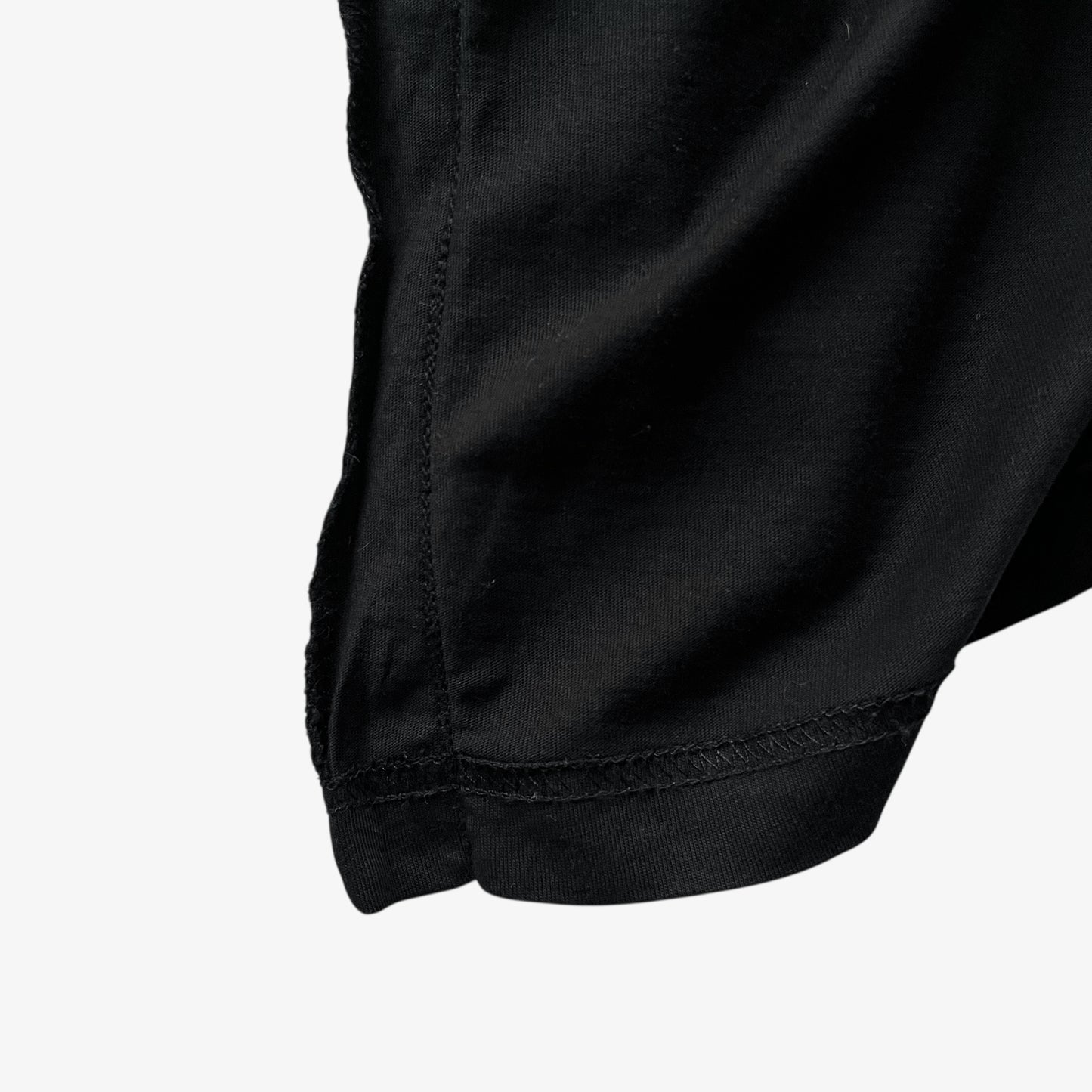 Tailored lining of men's Versace Jeans Couture rhinestone baroque sun face print black t-shirt.